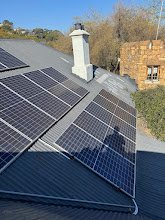 Solar panel array on a corrugated roof