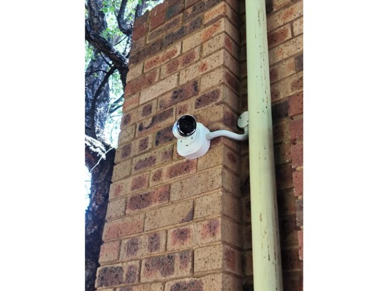 Outdoor bullet CCTV camera mounted on a brick wall